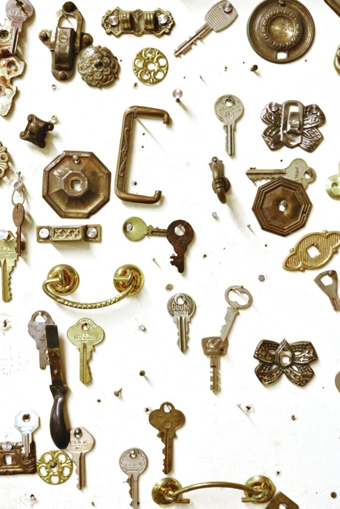 Assorted vintage keys and hardware showcased on a white background, highlighting intricate designs.